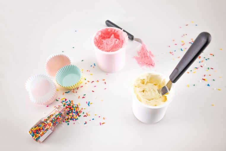 cupcake papers with frosting and sprinkles