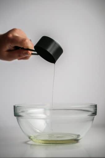 oil being poured into a bowl