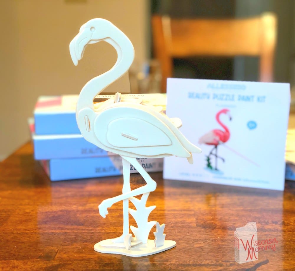 completed wooden flamingo puzzle on table