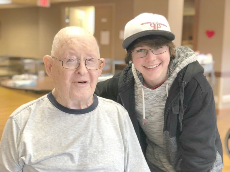 older man and teen smiling at camera