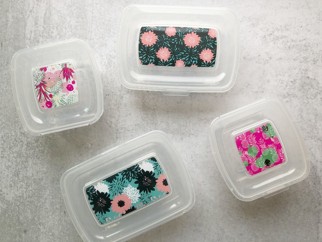 four containers with pretty floral degign on top and attached lids