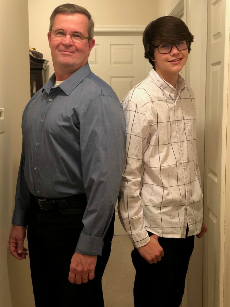 two men nicely dressed standing back to back