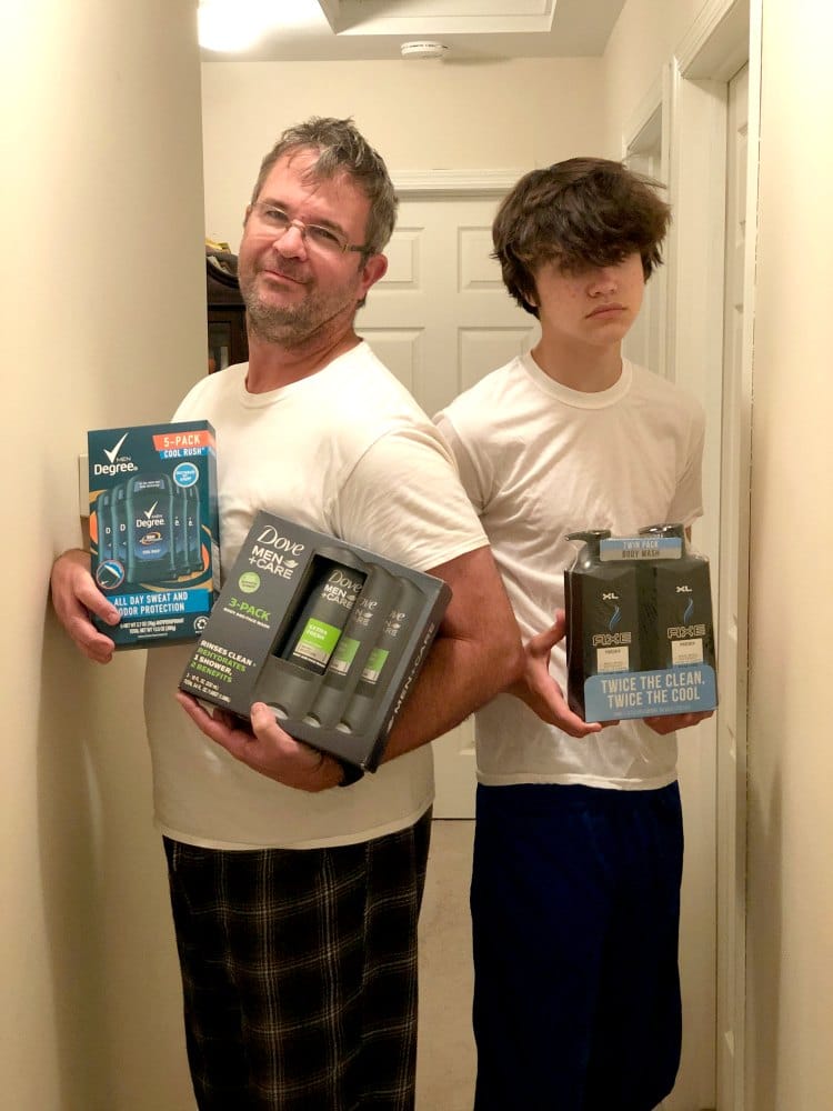two men holding bath products from Dove and AXE