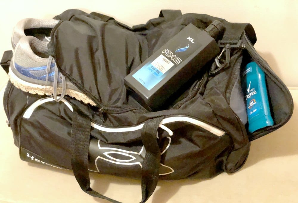 a black gym bag with shower gel bottle on top