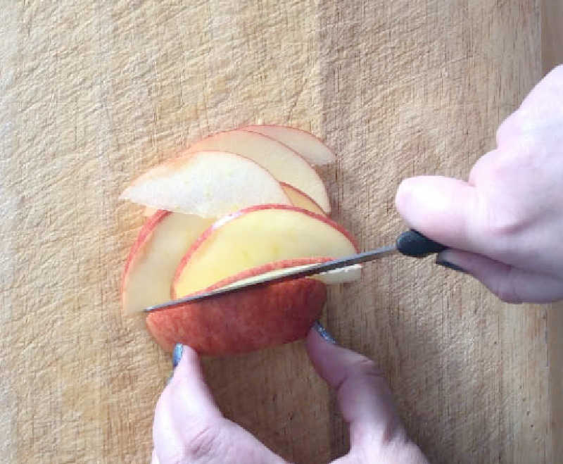knife slicing apple