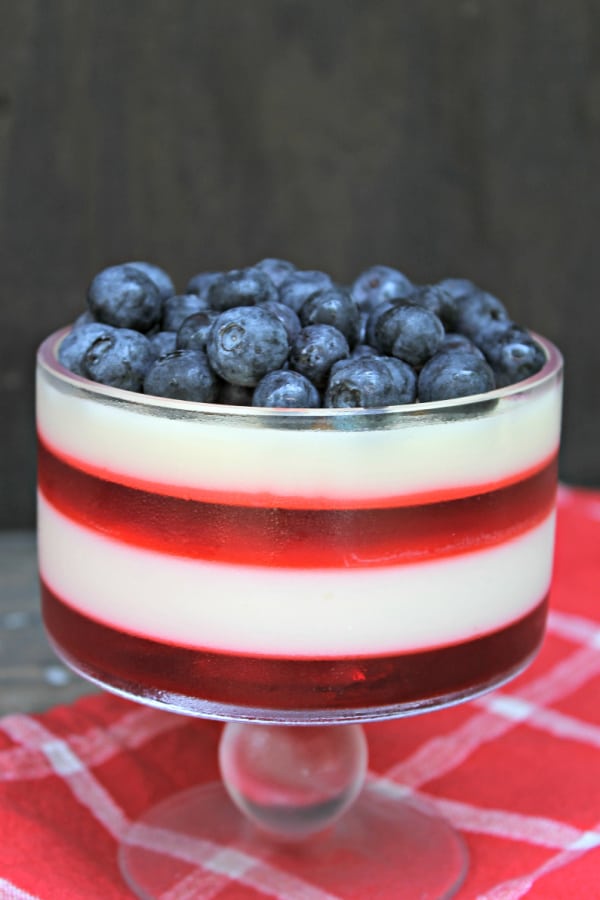 parfait of red and white jello with blueberries on top