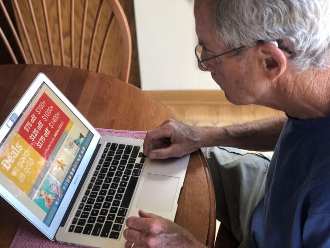 man typing on laptop computer