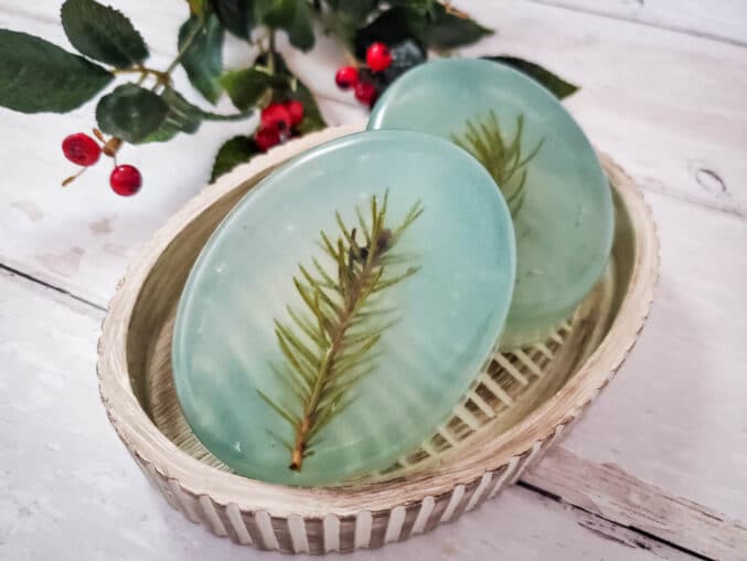 two bars of light green oine scented soap in a soapdish