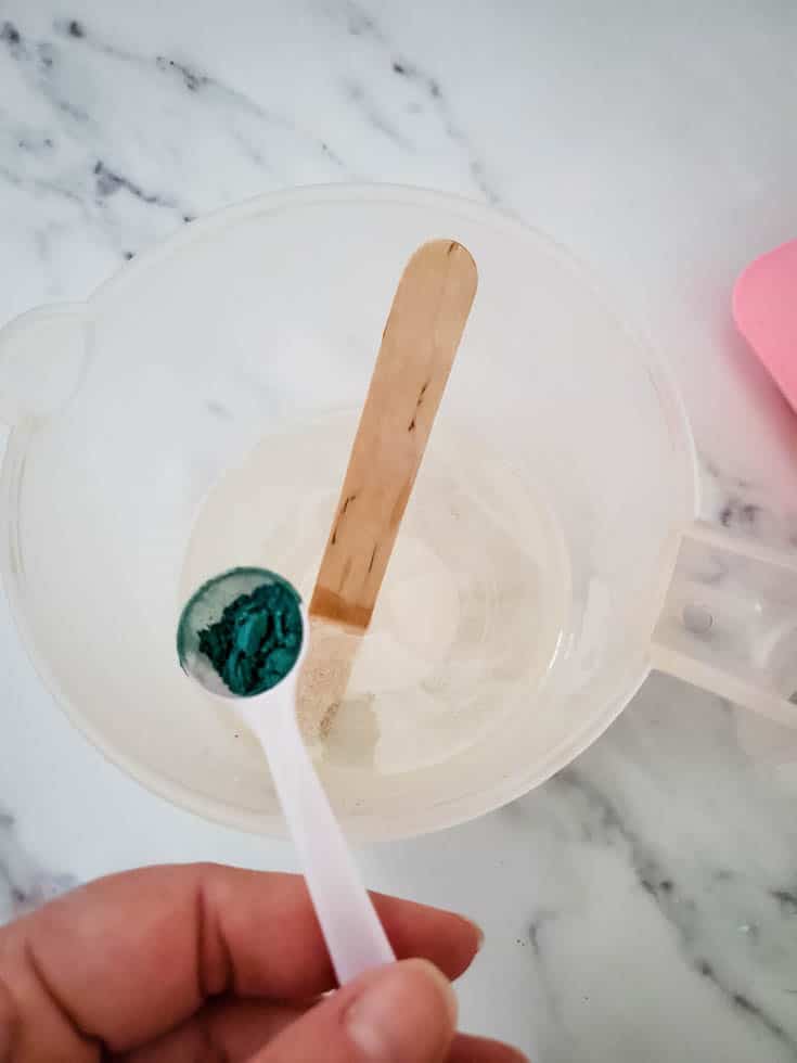 melted soap and spoonful of coloring