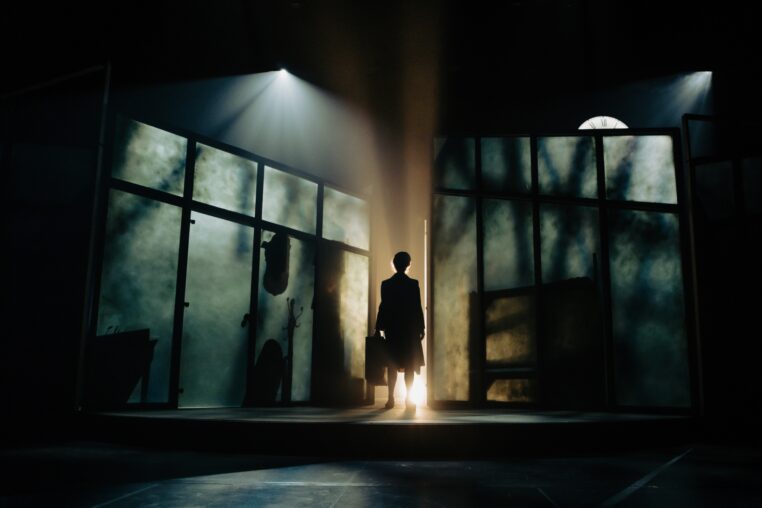 woman on a darkened stage