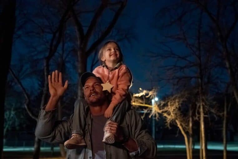 Man with daughter on his shoulders