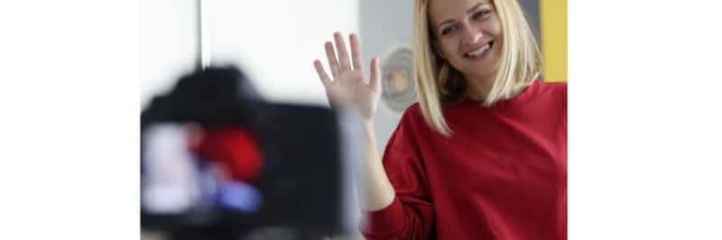 Woman waving to camera